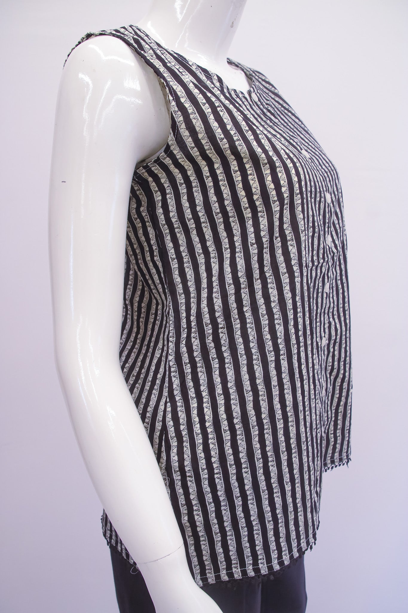 Mannequin wearing a black and white striped sleeveless top on a white background