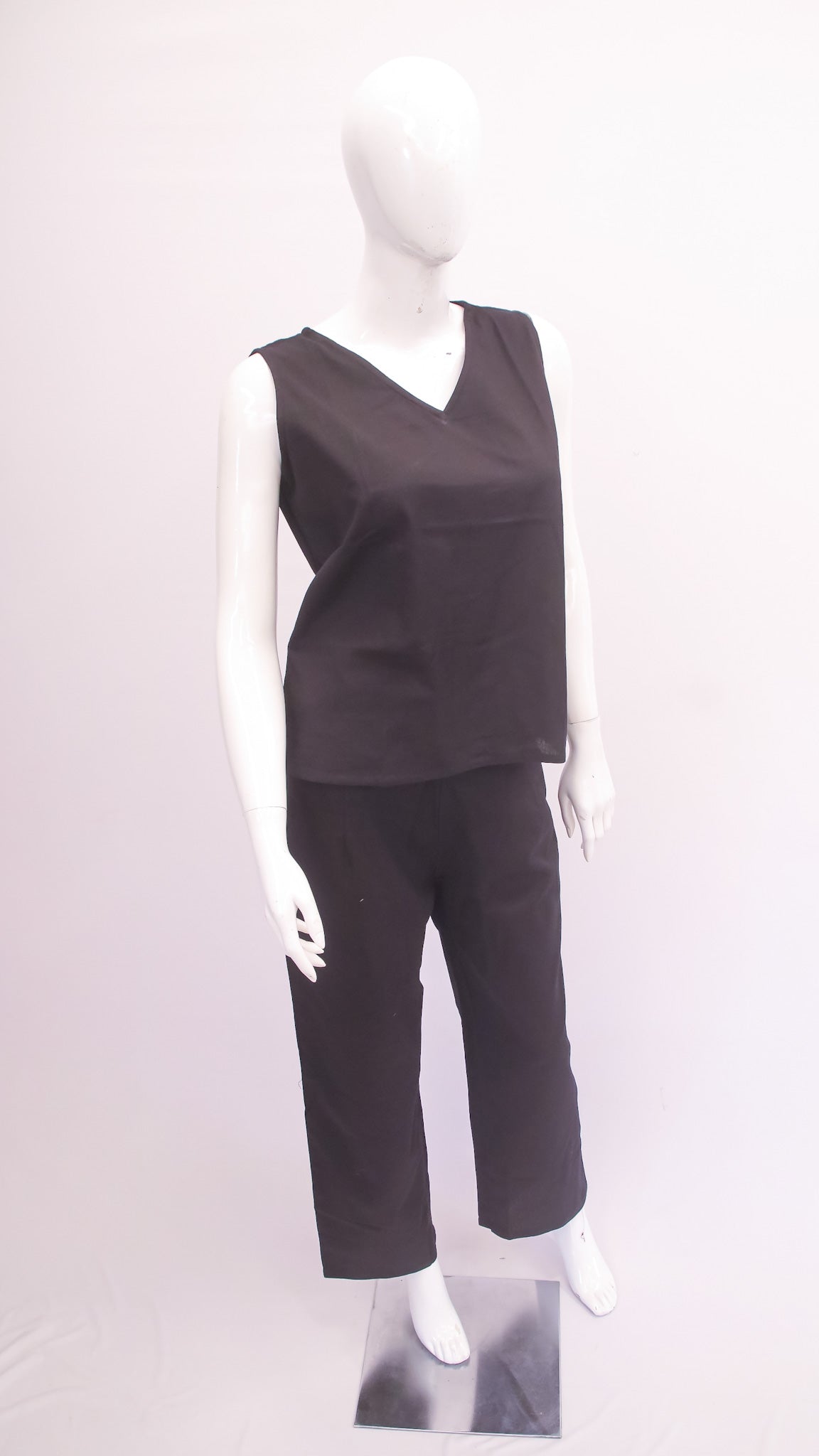 Mannequin wearing a black sleeveless top and pants on a white background