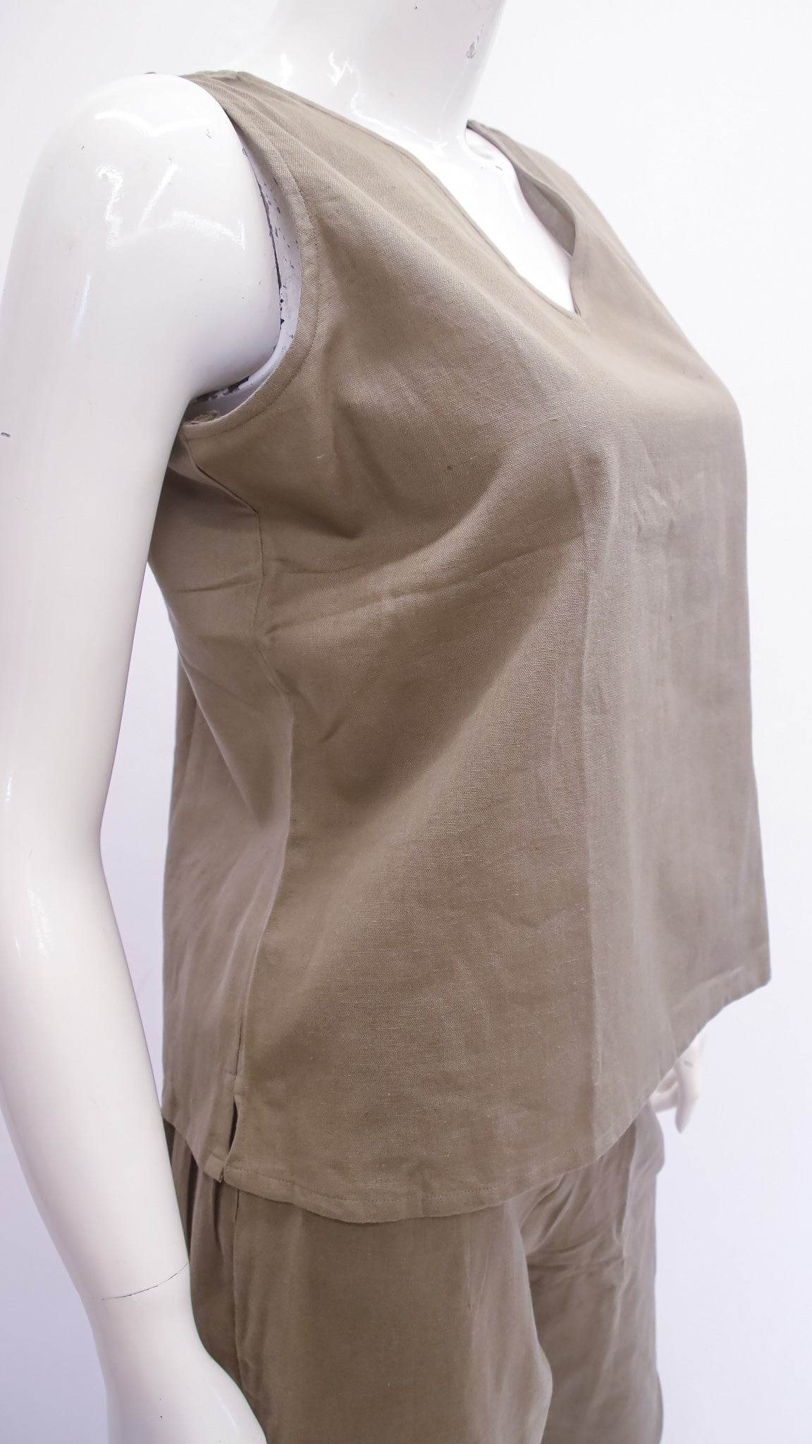 Beige sleeveless top on a mannequin against a white background