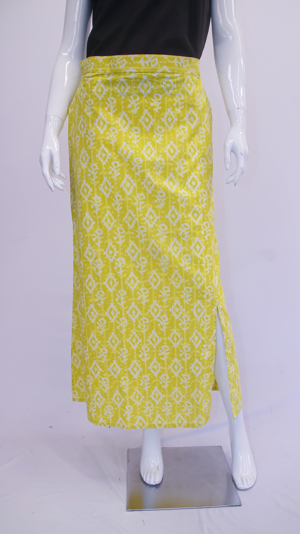 Mannequin wearing a yellow patterned skirt on a white background