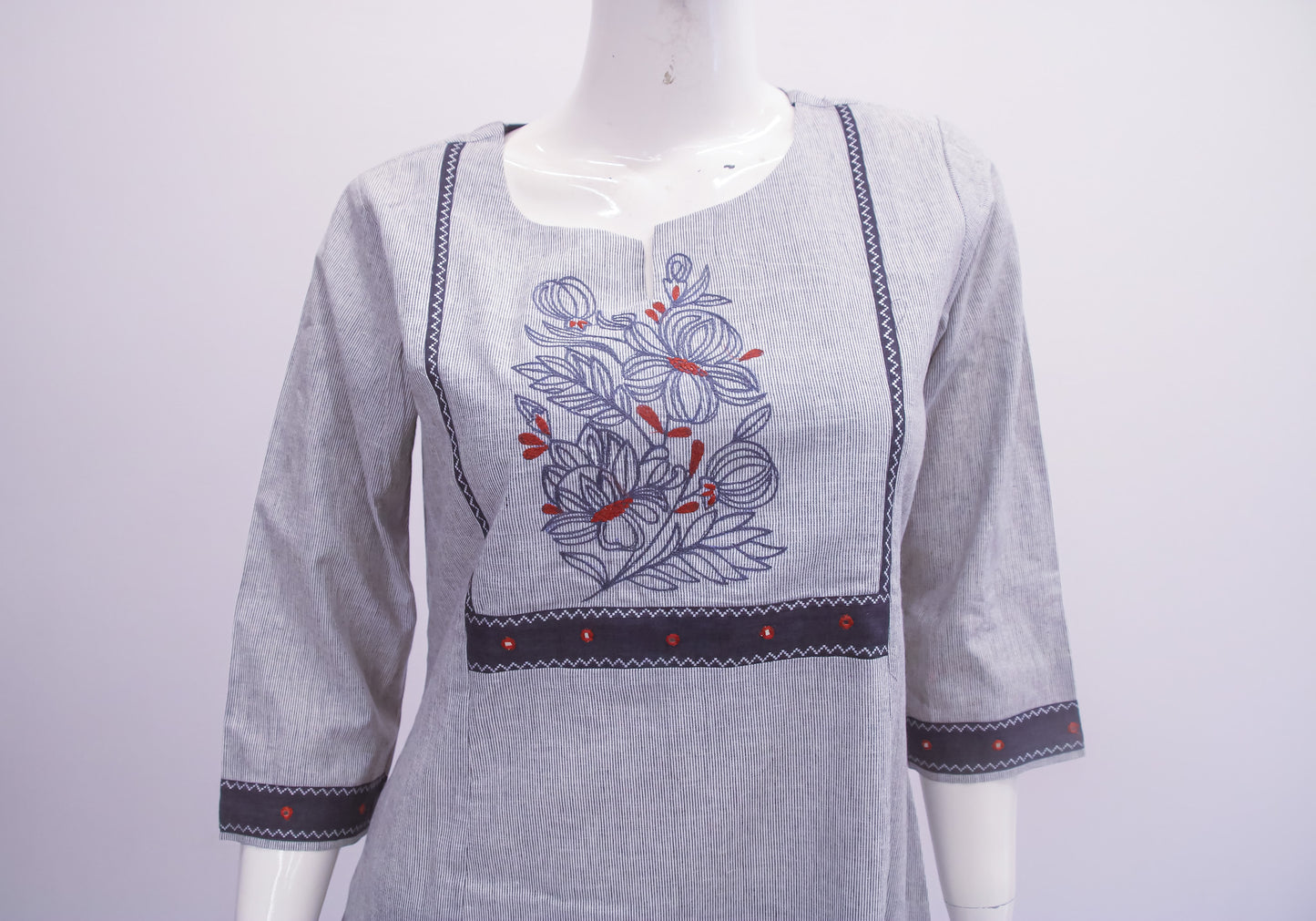 Gray kurta with floral embroidery on a mannequin against a white background
