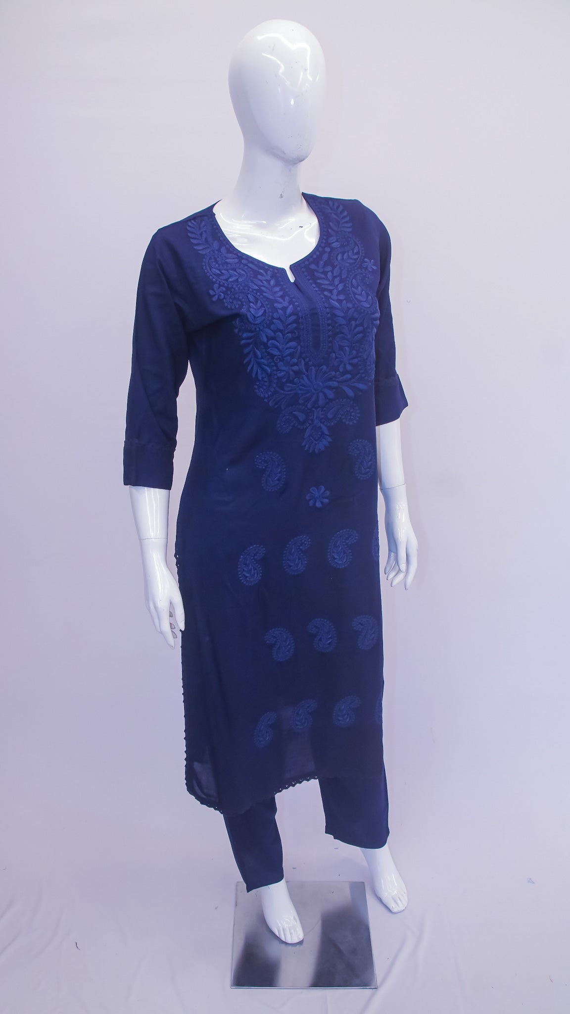 Navy blue dress with floral patterns on a mannequin against a light gray background