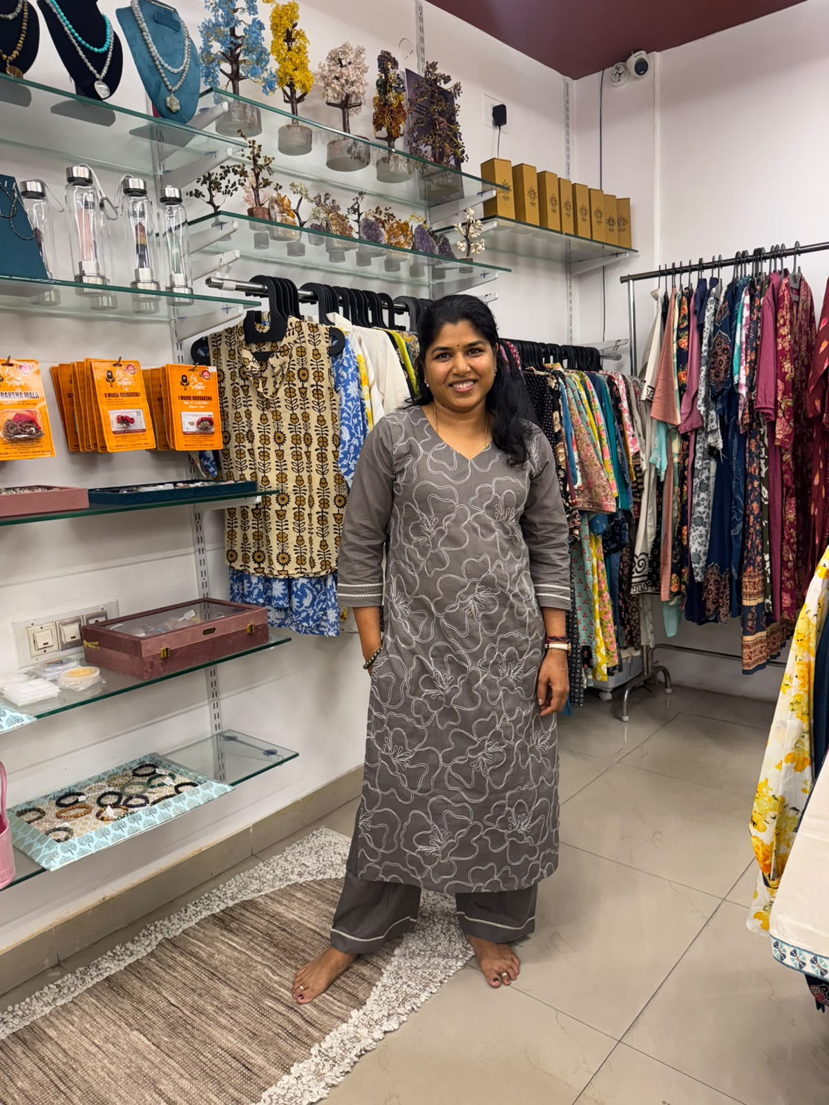 Grey kurta pant set for women featuring white floral embroidery, V-neckline, three-quarter sleeves and matching pants.