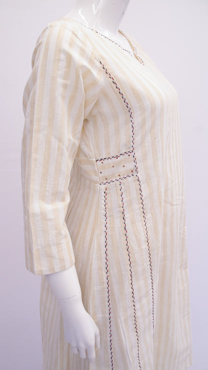 Mannequin wearing a beige and white striped dress with intricate detailing on a white background