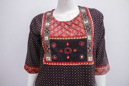 Traditional outfit with red and black patterns on a white background