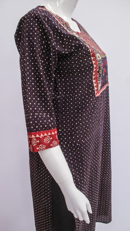 Black patterned dress with red accents on a mannequin against a white background