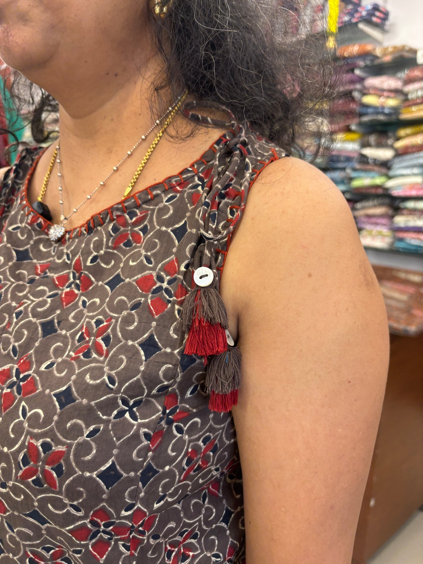 Person wearing a patterned top with a blurred background