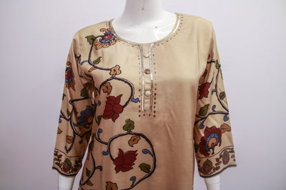 Beige blouse with floral embroidery on a mannequin against a white background
