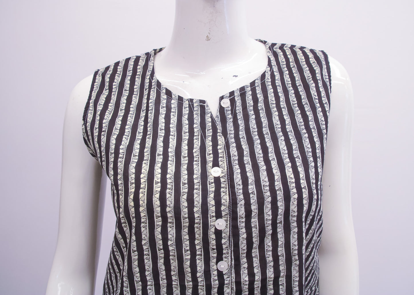 Black and white striped shirt on a mannequin against a white background