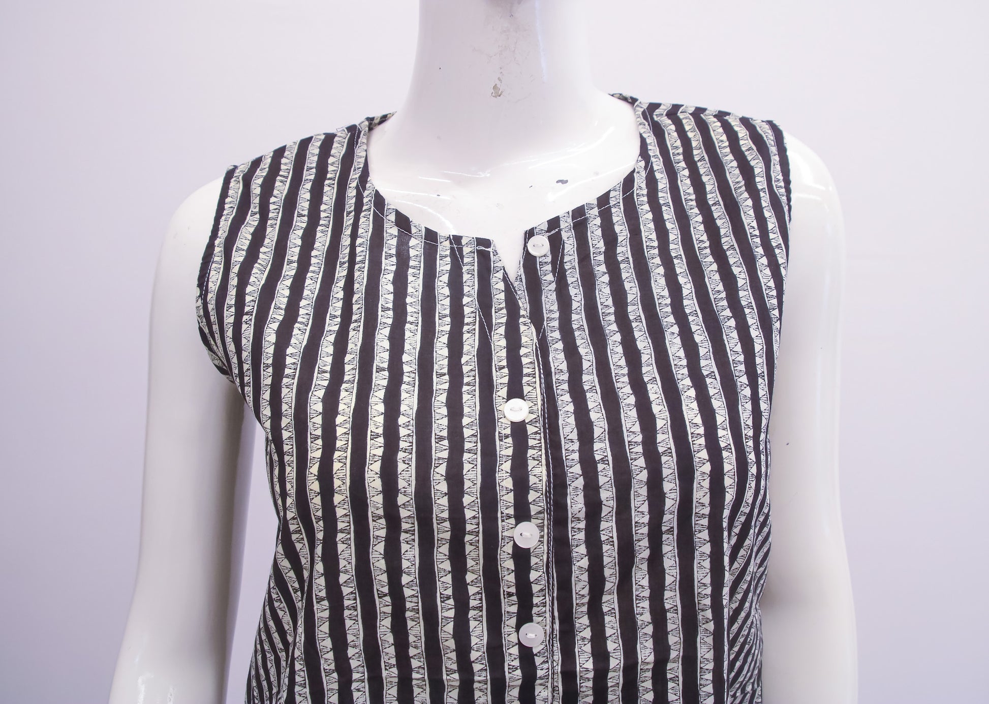 Black and white striped shirt on a mannequin against a white background