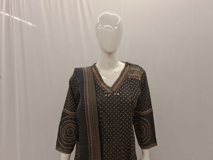 Black patterned dress on a mannequin against a plain background