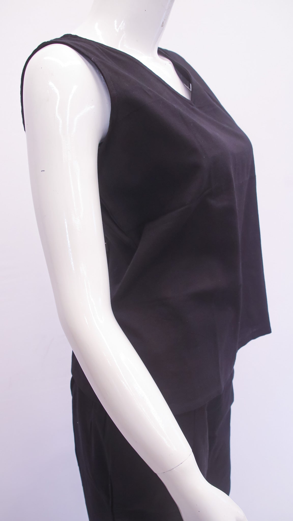 Black sleeveless top on a mannequin against a white background