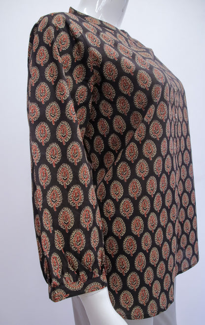Mannequin wearing a black patterned top on a white background