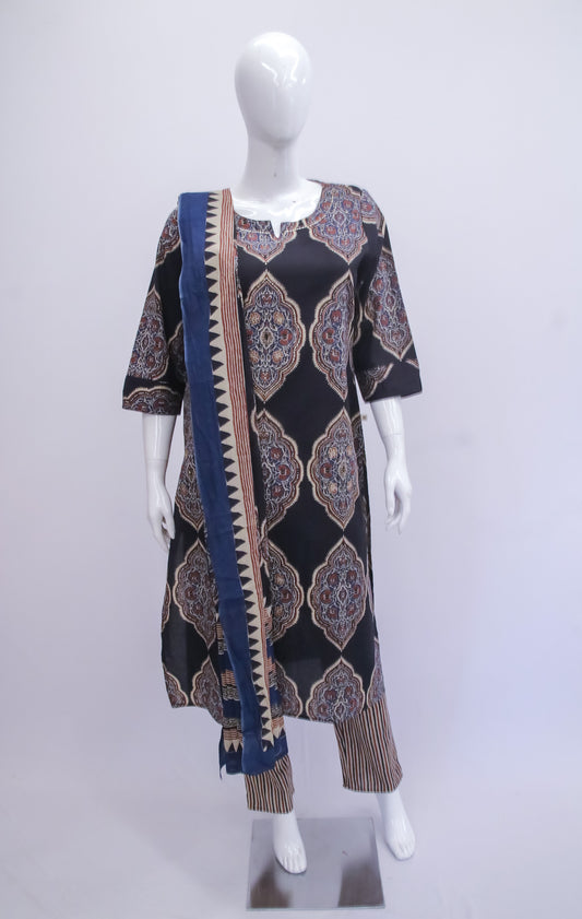 Mannequin wearing a black patterned dress with a blue and brown scarf on a white background