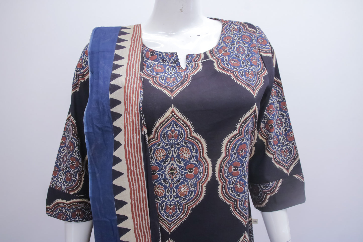 Mannequin wearing a patterned top with a blue accent on a white background
