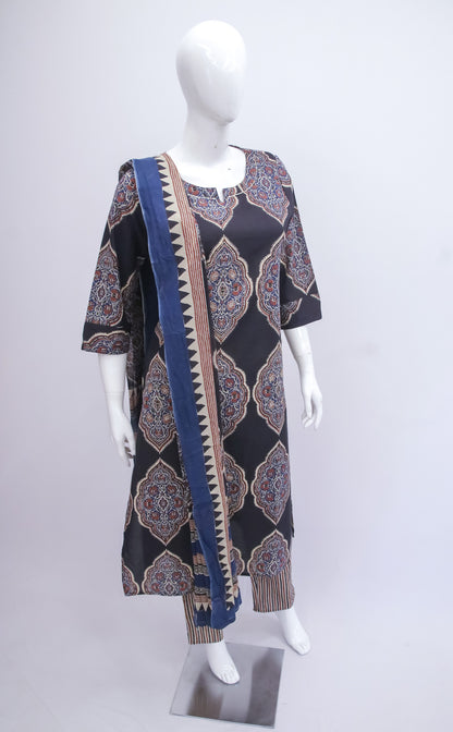 Mannequin wearing a patterned dress with a long scarf on a white background