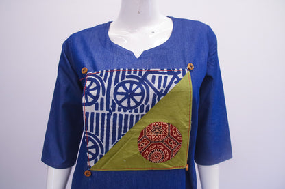 Blue dress with geometric patterns on a mannequin against a white background