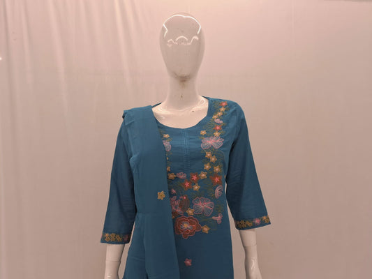 Blue embroidered dress on a mannequin against a plain background