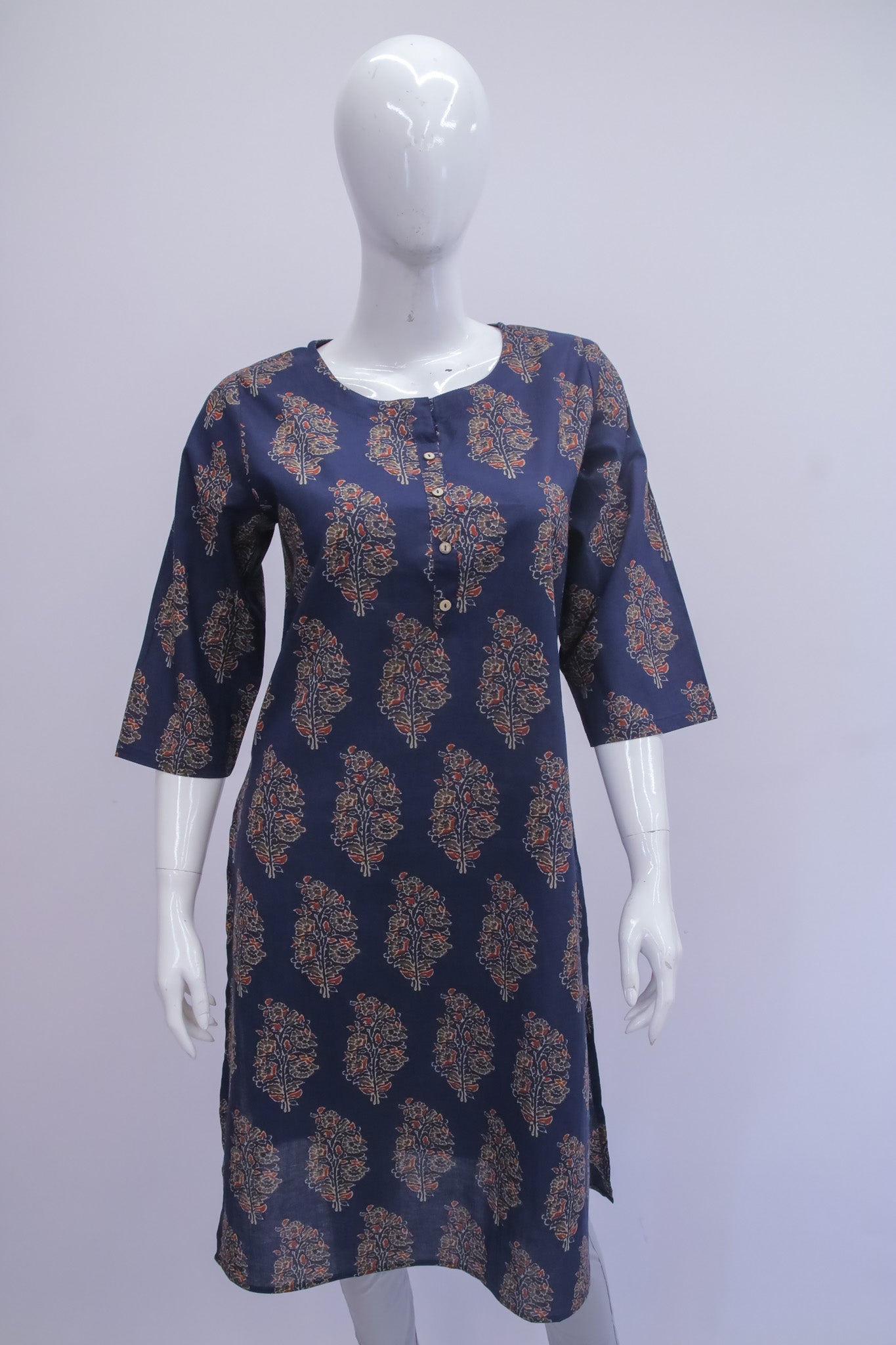 Navy blue dress with gold patterns on a mannequin against a white background