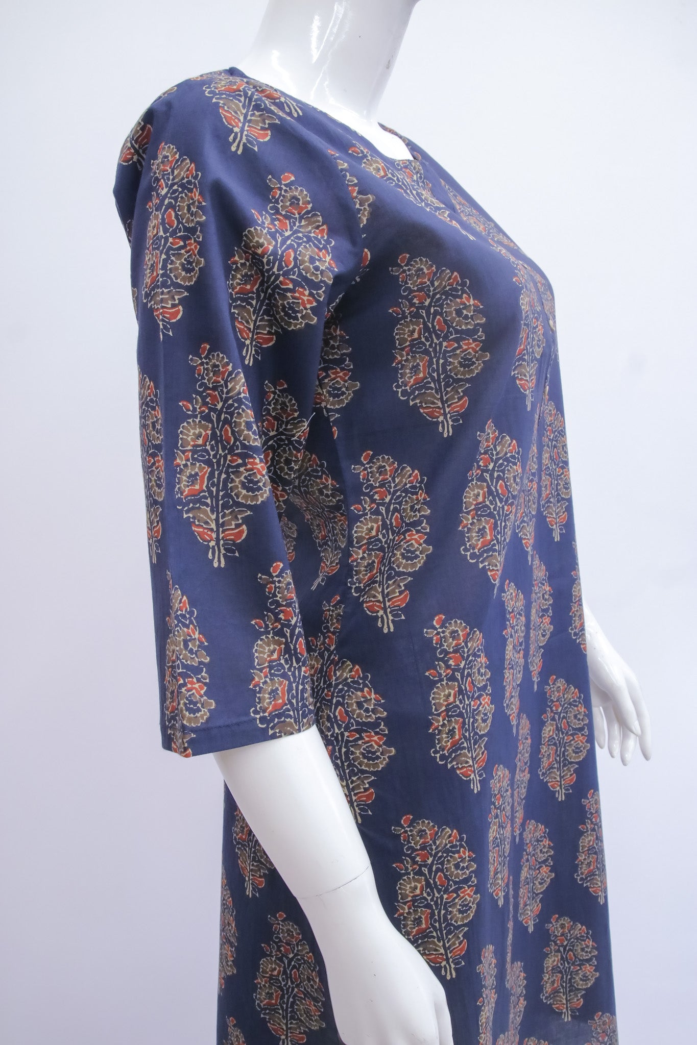 Navy blue dress with floral pattern on a white mannequin against a white background