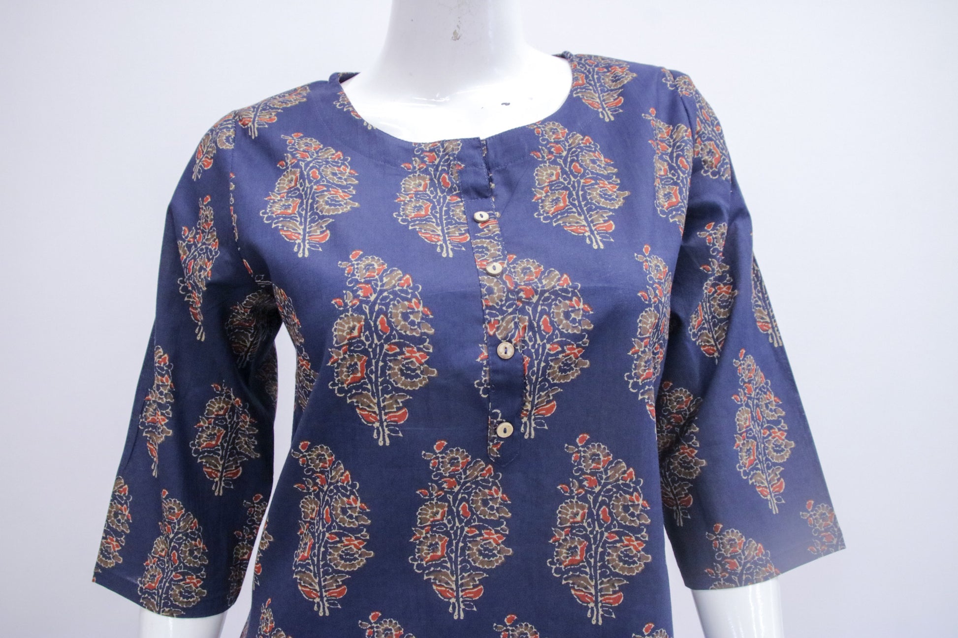 Navy blue blouse with floral pattern on a mannequin against a white background