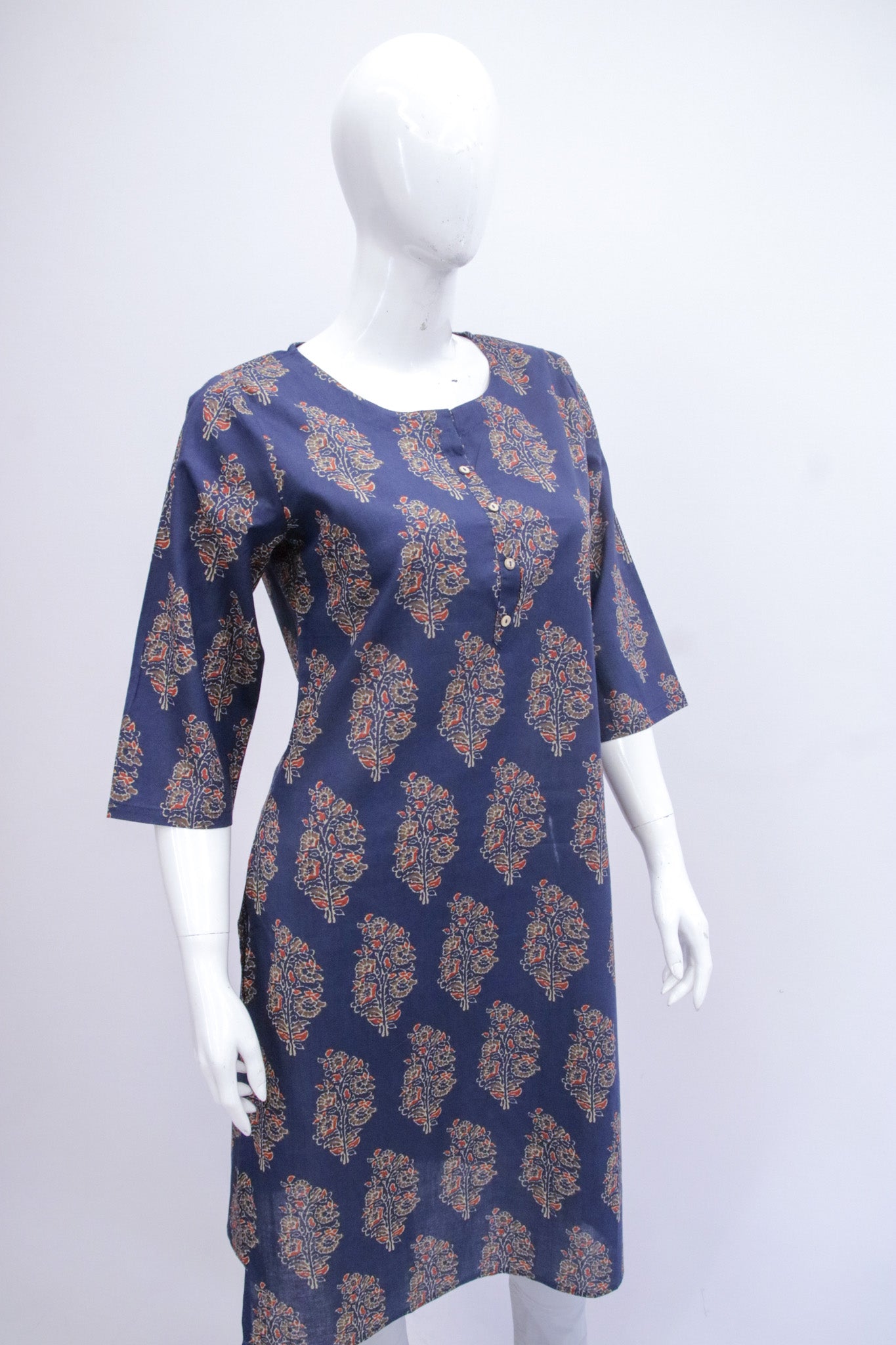 Navy blue dress with gold floral pattern on a mannequin against a white background