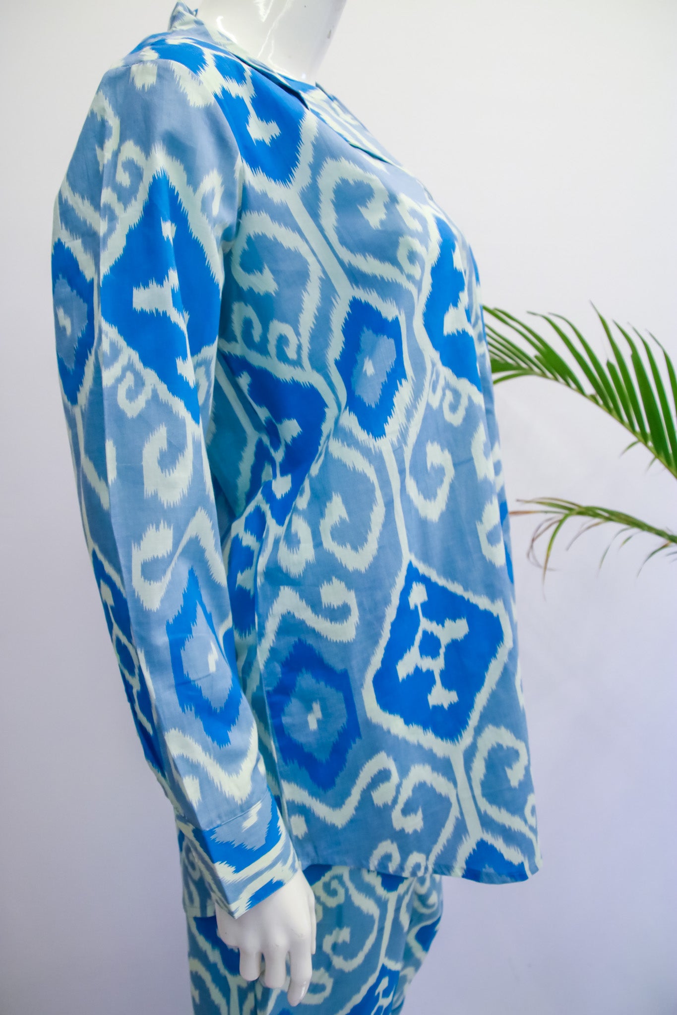 Blue and white patterned dress on a mannequin with a white background