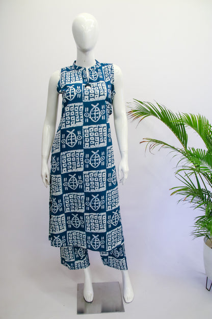 Mannequin wearing a blue and white patterned dress with a plant in the background