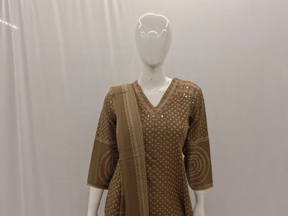 Brown patterned outfit on a mannequin against a plain background