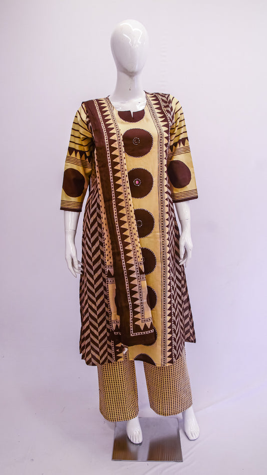 Mannequin wearing a patterned outfit with a long top and pants on a light gray background