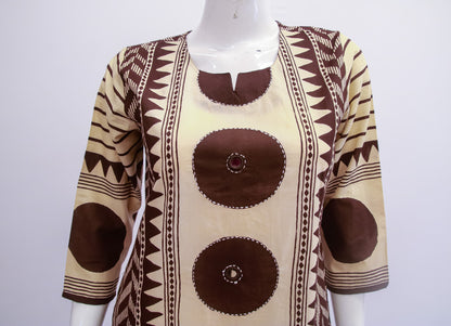 Mannequin wearing a patterned top with brown and beige design on a white background