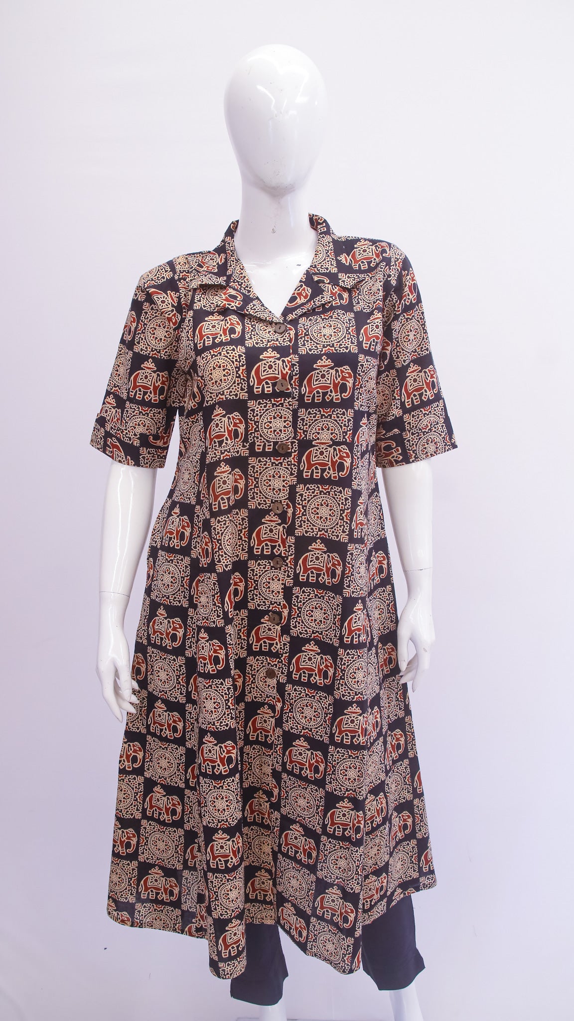 Mannequin wearing a patterned dress on a white background