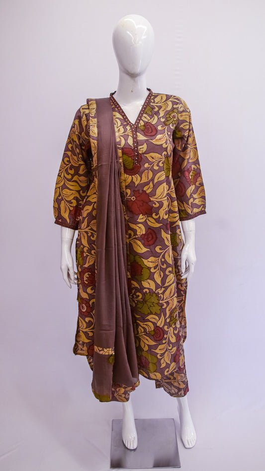 Mannequin wearing a patterned dress with a matching shawl on a white background