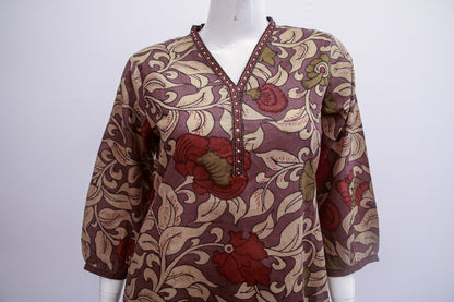 Patterned blouse on a mannequin against a white background