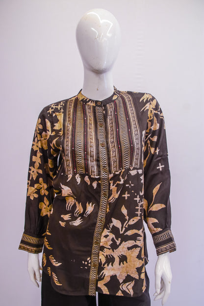 Mannequin wearing a patterned shirt with a white background