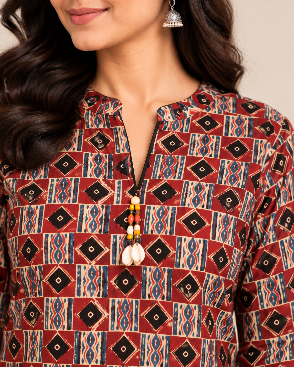 Maroon geometric printed cotton short kurti with multicolour ethnic motifs and tassel neckline