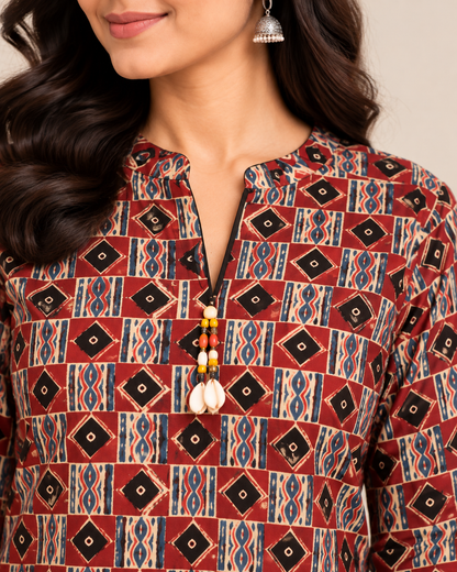 Maroon geometric printed cotton short kurti with multicolour ethnic motifs and tassel neckline