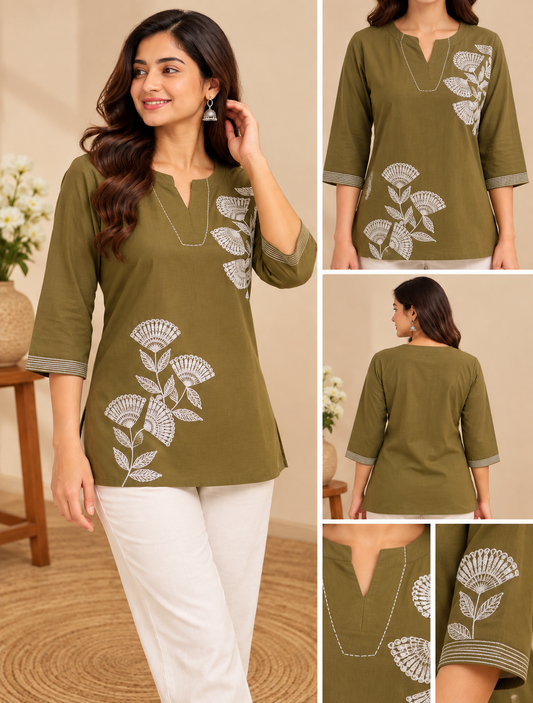 Olive green embroidered short kurti with white floral embroidery, V-neckline, three-quarter sleeves and striped cuff detailing, styled on a female model