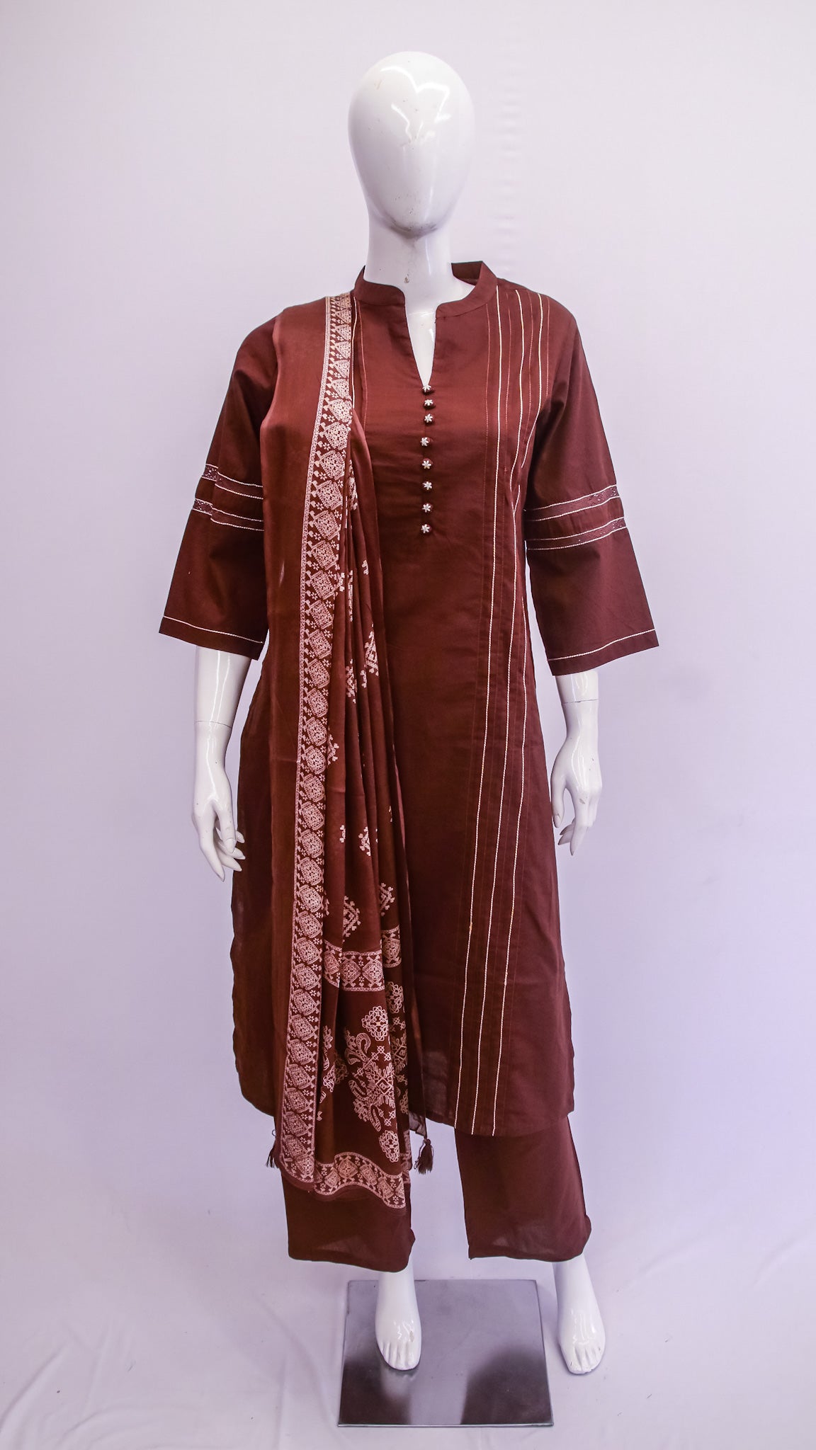 Brown traditional outfit with a matching dupatta on a mannequin against a white background