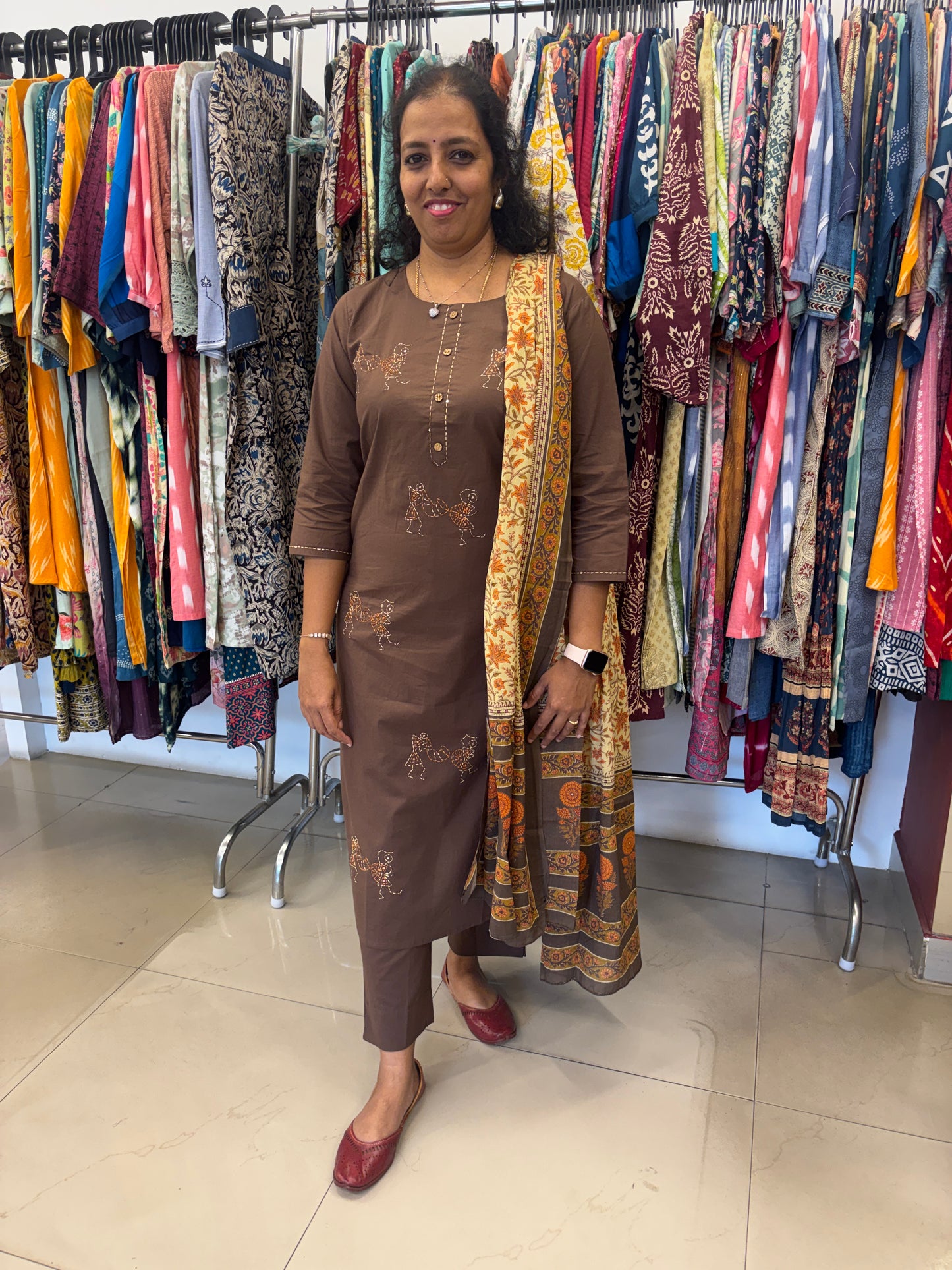 Woman standing among colorful fabrics in a store
