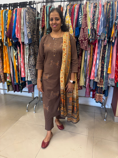 Woman standing among colorful fabrics in a store