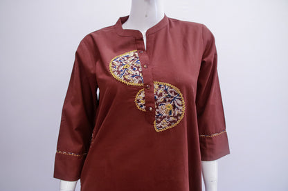 Brown shirt with floral embroidery on a mannequin against a white background