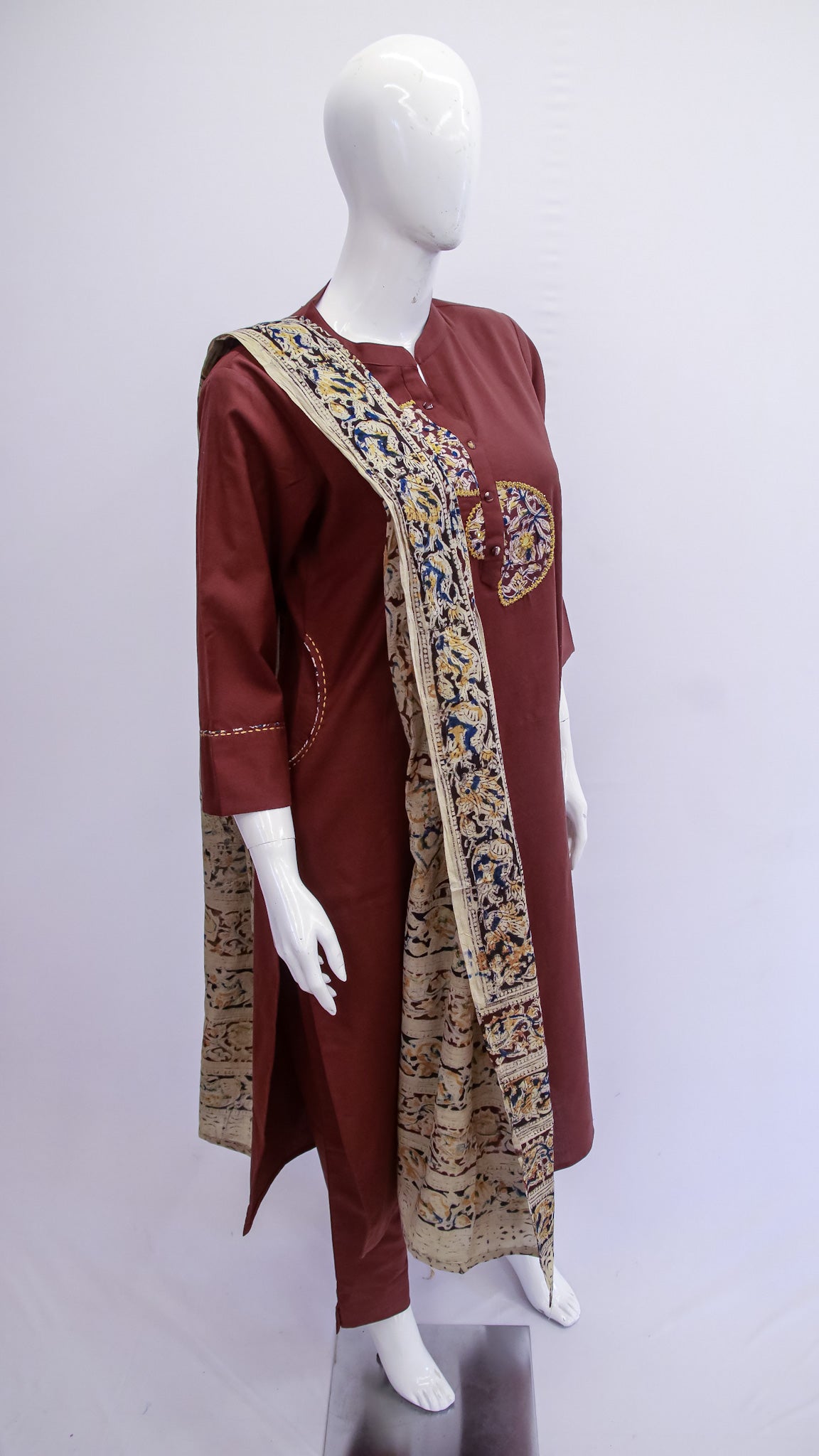 Maroon traditional outfit with a patterned dupatta on a mannequin against a white background