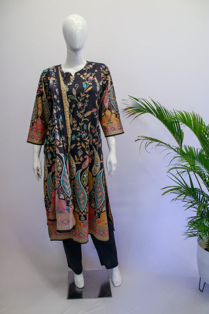 Mannequin wearing a colorful patterned outfit with a plant in the background