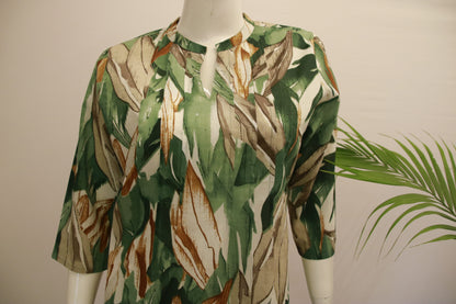 A mannequin displaying a green and beige geometric patterned cotton co-ord set with 3/4 sleeves and a collared neck.