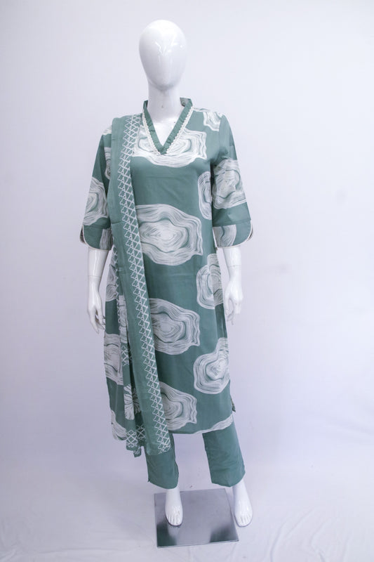 Green and white patterned outfit on a mannequin against a white background