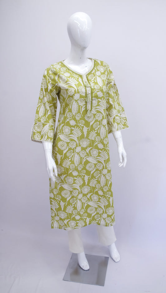 Green and white patterned dress on a mannequin against a white background