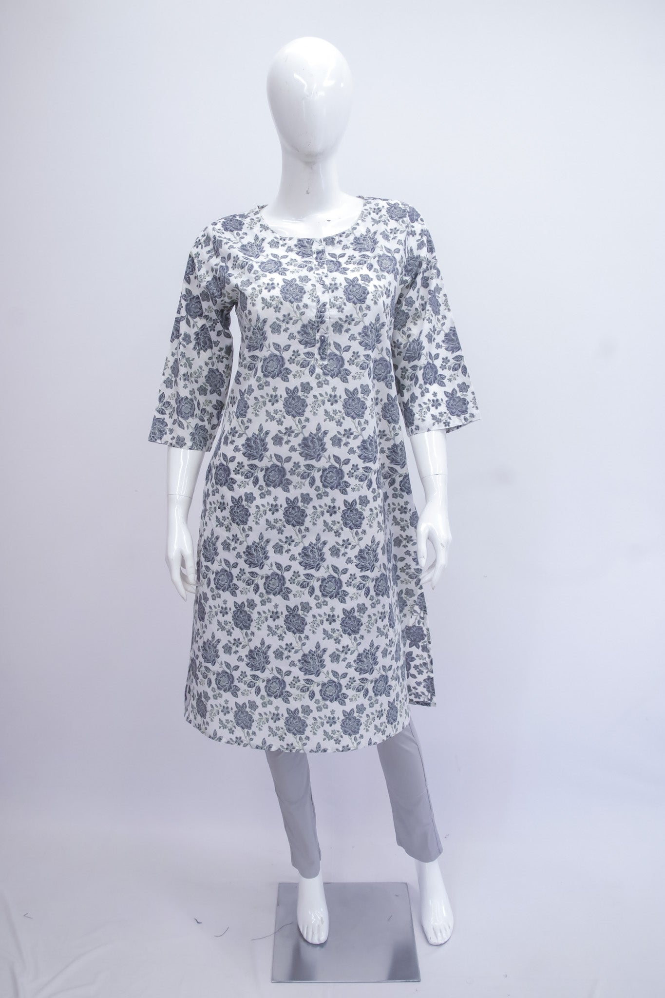 Floral patterned dress on a mannequin against a white background