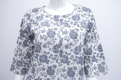 White blouse with blue floral pattern on a mannequin against a white background