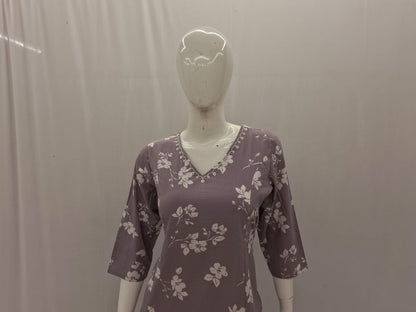 Mannequin wearing a purple floral dress against a plain background